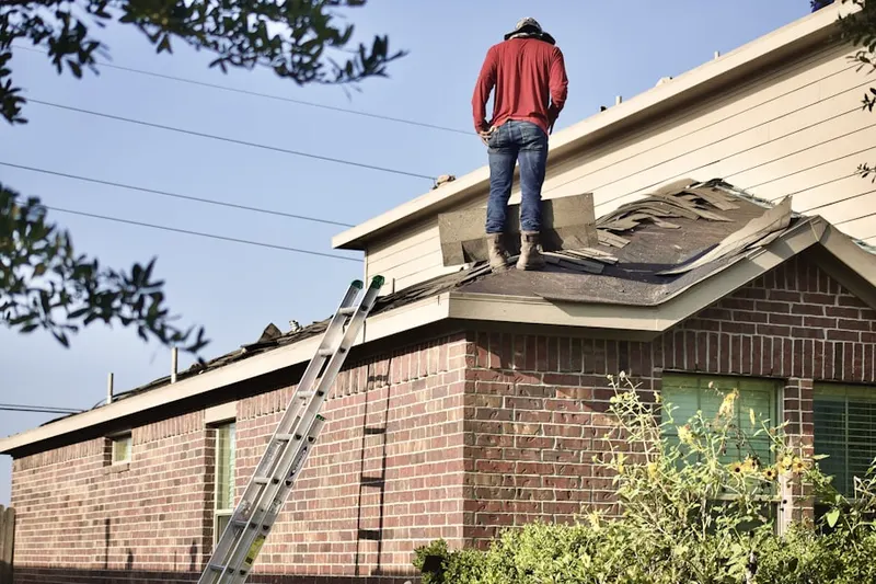 Professional roofer working on a residential roof in The Arbors of Creekwood